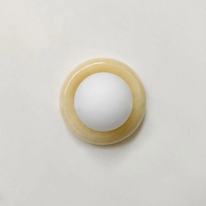 Compact Onyx Wall Light featuring a sleek design with a soft white glass diffuser, ideal for creating ambient lighting; dimmable hardwired fixture perfect for 13