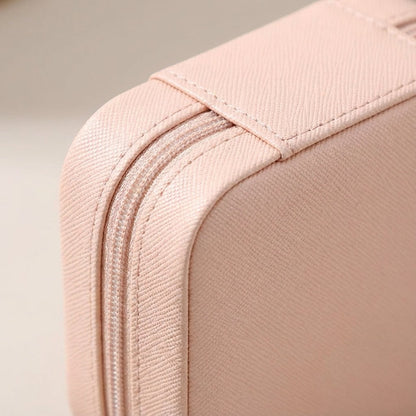 Compact travel jewelry box featuring a soft leather finish, designed for lightweight portability and protective storage of jewelry items. 3