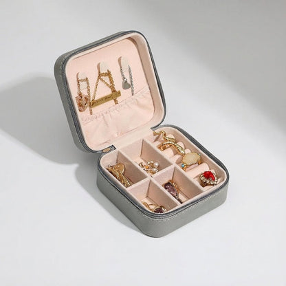 Compact travel jewelry box featuring a soft leather finish, designed for lightweight portability and protective storage of jewelry items. 6