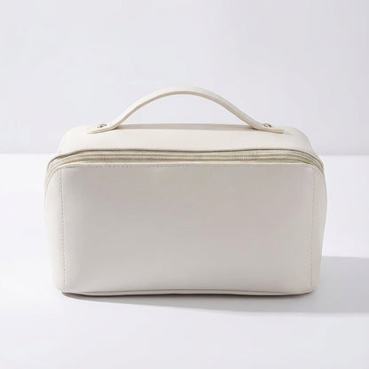 Compact travel makeup bag featuring multiple compartments and a sturdy handle, designed for organizing beauty essentials in a glossy cosmetic pouch. 0