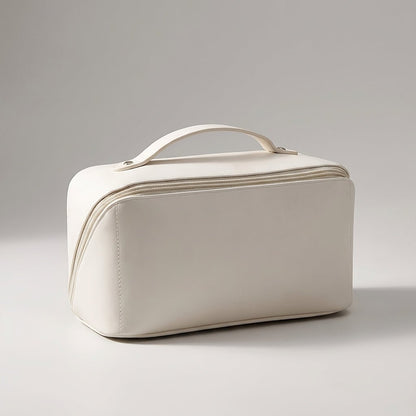 Compact travel makeup bag featuring multiple compartments and a sturdy handle, designed for organizing beauty essentials in a glossy cosmetic pouch. 2