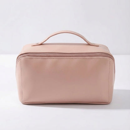 Compact travel makeup bag featuring multiple compartments and a sturdy handle, designed for organizing beauty essentials in a glossy cosmetic pouch. 5
