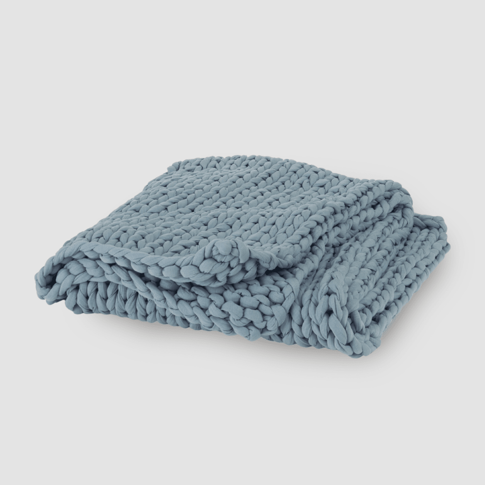 Cooling weighted blanket featuring a knit chunky design, made from breathable TENCEL™ fabric, available in various colors for enhanced comfort and style. 4
