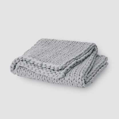 Cooling weighted blanket featuring a knit chunky design, made from breathable TENCEL™ fabric, available in various colors for enhanced comfort and style. 3