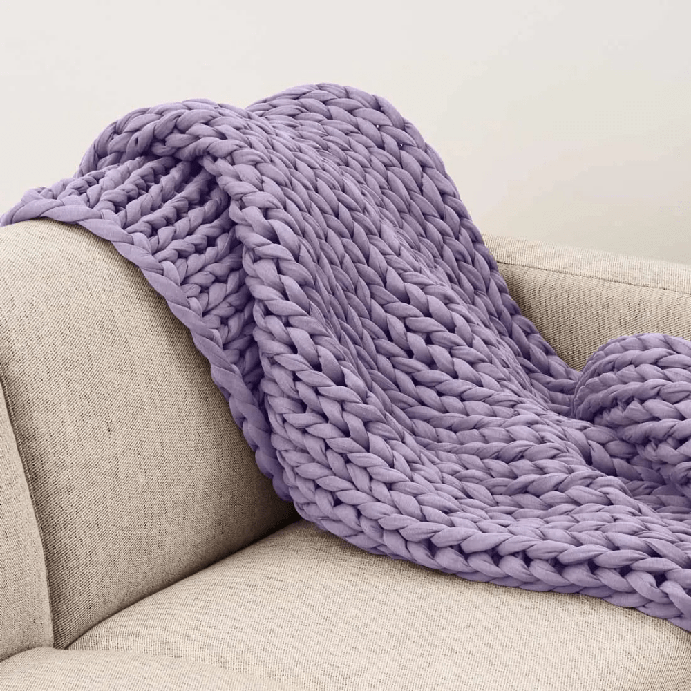 Cooling weighted blanket featuring a knit chunky design, made from breathable TENCEL™ fabric, available in various colors for enhanced comfort and style. 6