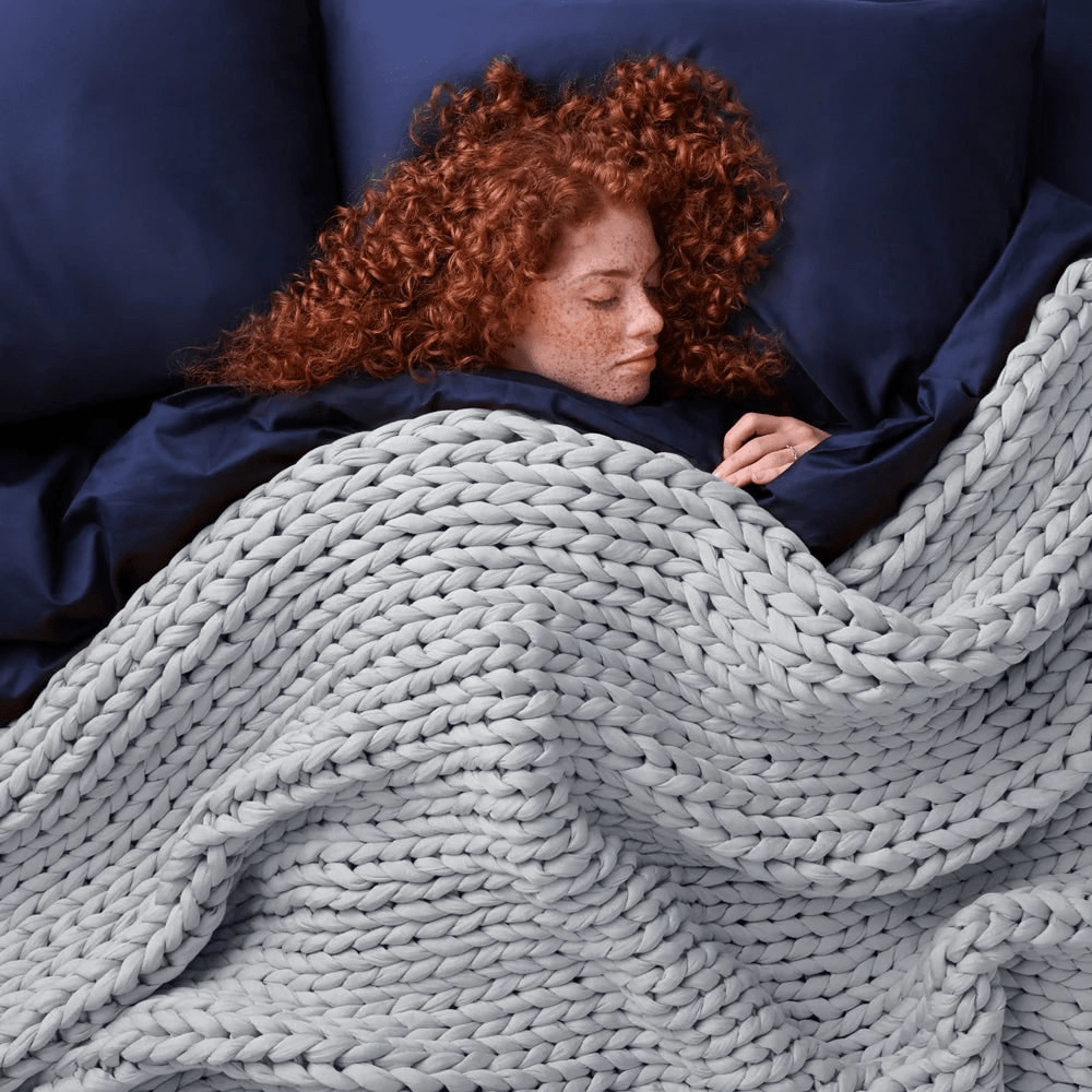 Cooling weighted blanket featuring a knit chunky design, made from breathable TENCEL™ fabric, available in various colors for enhanced comfort and style. 7
