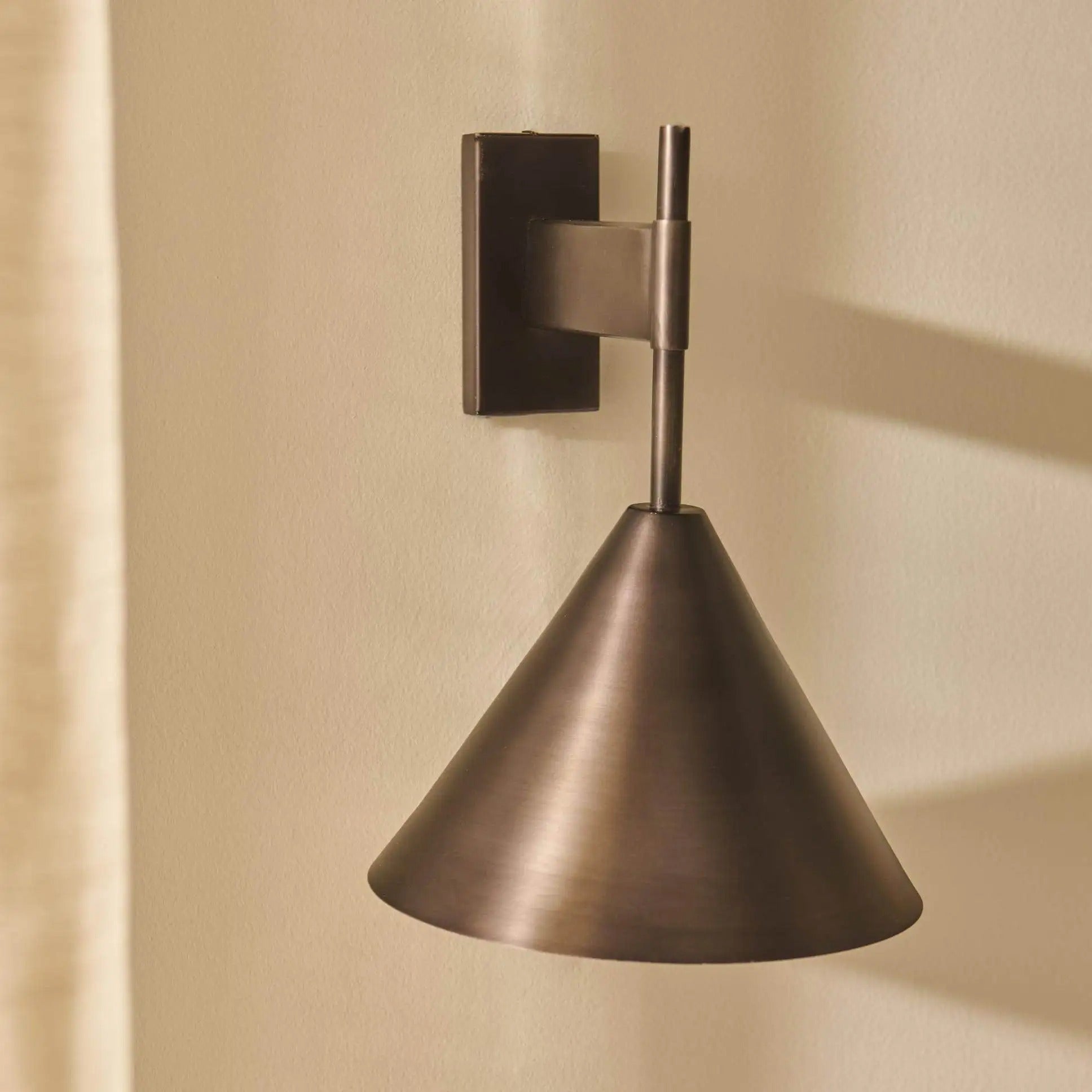 Copper wall lamp featuring a sleek conical shade, available in elegant gold or black finishes, perfect for contemporary home decor. 0