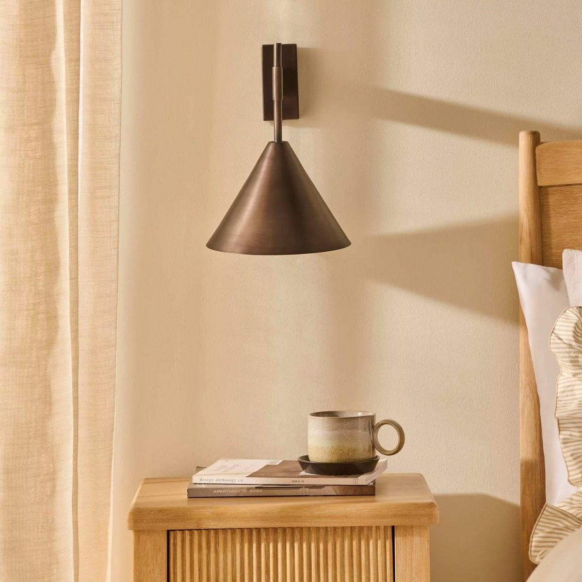 Copper wall lamp featuring a sleek conical shade, available in elegant gold or black finishes, perfect for contemporary home decor. 1