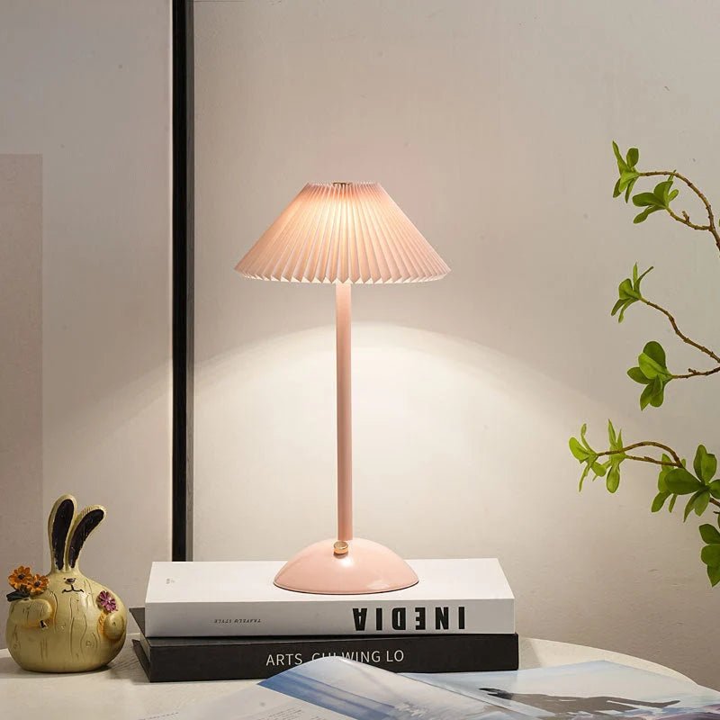 Scandinavian style cordless table lamp featuring a pleated fabric shade and sturdy iron base, perfect for enhancing the ambiance of bedrooms or dining areas. 2