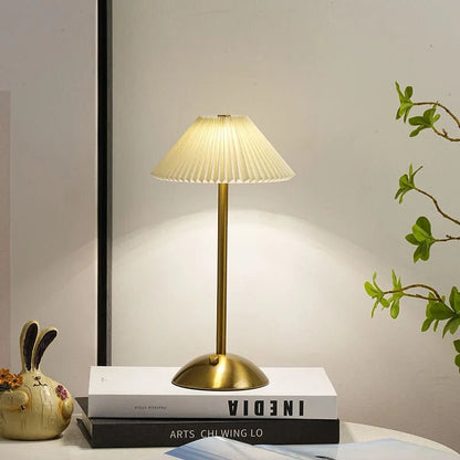 Scandinavian style cordless table lamp featuring a pleated fabric shade and sturdy iron base, perfect for enhancing the ambiance of bedrooms or dining areas. 3