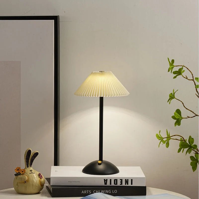 Scandinavian style cordless table lamp featuring a pleated fabric shade and sturdy iron base, perfect for enhancing the ambiance of bedrooms or dining areas. 5