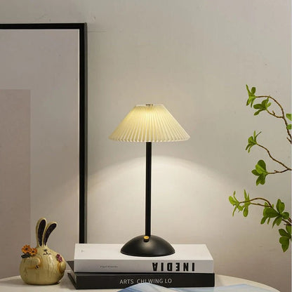 Scandinavian style cordless table lamp featuring a pleated fabric shade and sturdy iron base, perfect for enhancing the ambiance of bedrooms or dining areas. 5