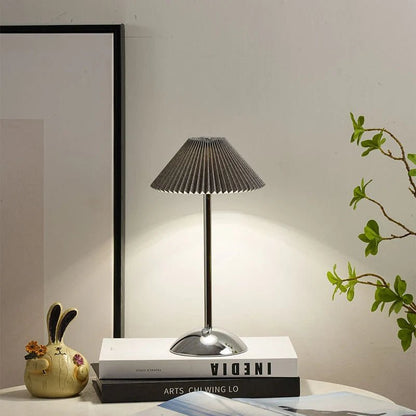 Scandinavian style cordless table lamp featuring a pleated fabric shade and sturdy iron base, perfect for enhancing the ambiance of bedrooms or dining areas. 4