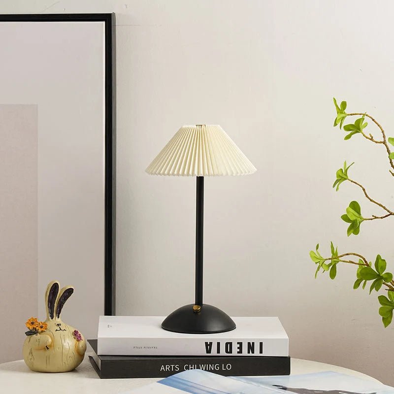 Scandinavian style cordless table lamp featuring a pleated fabric shade and sturdy iron base, perfect for enhancing the ambiance of bedrooms or dining areas. 11