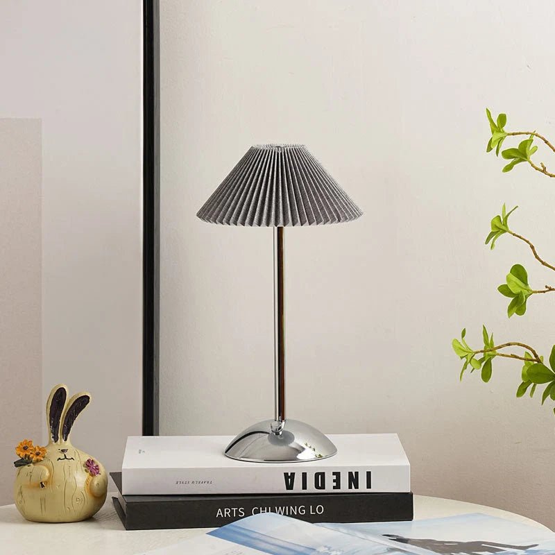Scandinavian style cordless table lamp featuring a pleated fabric shade and sturdy iron base, perfect for enhancing the ambiance of bedrooms or dining areas. 10