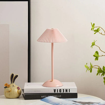 Scandinavian style cordless table lamp featuring a pleated fabric shade and sturdy iron base, perfect for enhancing the ambiance of bedrooms or dining areas. 15