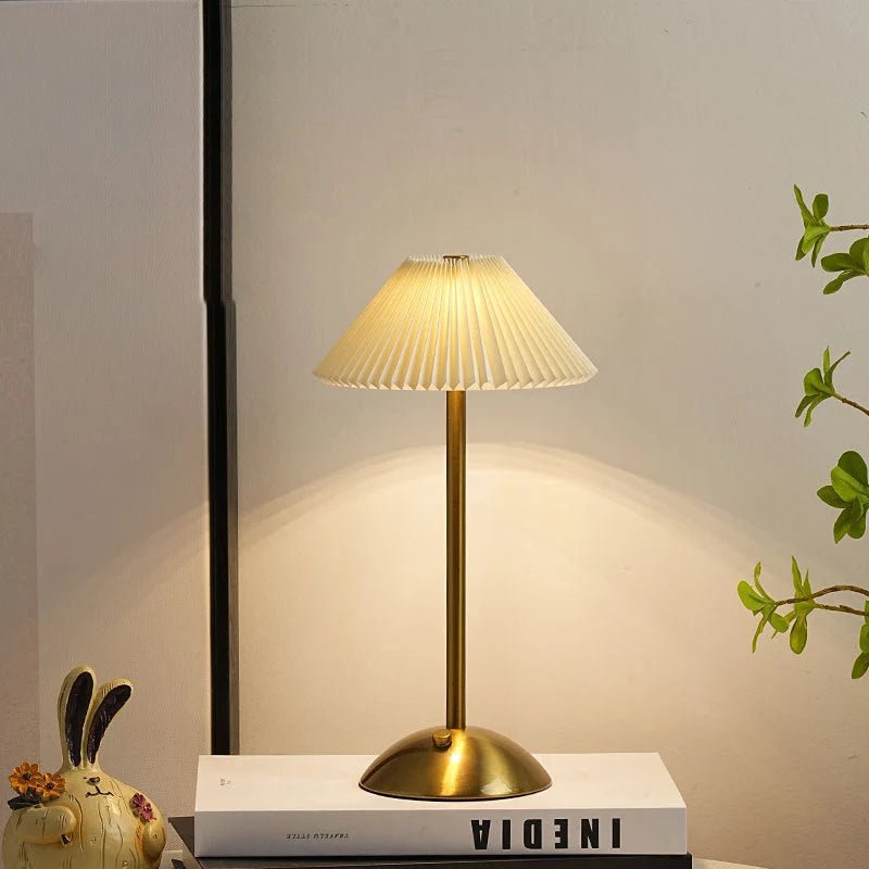 Scandinavian style cordless table lamp featuring a pleated fabric shade and sturdy iron base, perfect for enhancing the ambiance of bedrooms or dining areas. 1