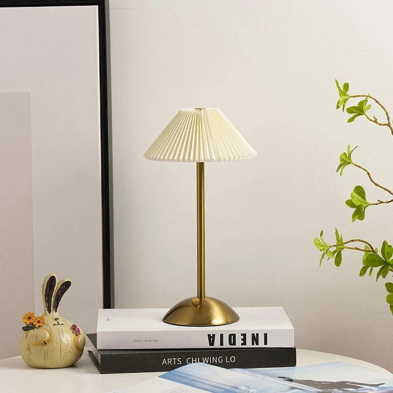 Scandinavian style cordless table lamp featuring a pleated fabric shade and sturdy iron base, perfect for enhancing the ambiance of bedrooms or dining areas. 0