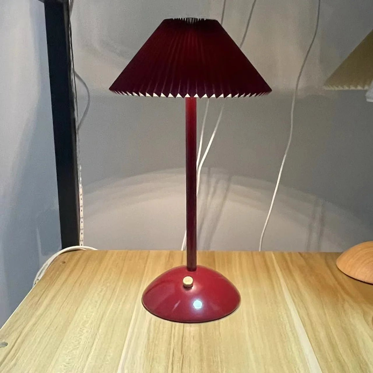 Scandinavian style cordless table lamp featuring a pleated fabric shade and sturdy iron base, perfect for enhancing the ambiance of bedrooms or dining areas. 14