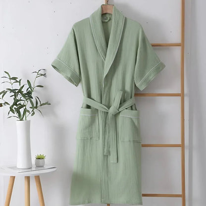 Cotton bathrobe for women with short sleeves, featuring a relaxed fit in double muslin fabric, designed for breathability and lightweight comfort. 2