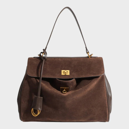 Cowhide leather shoulder bag featuring a magnetic flap closure, adjustable strap, and a lined interior for organized storage. 10
