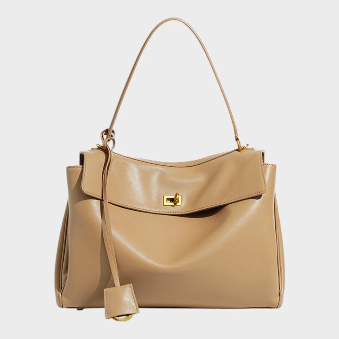 Cowhide leather shoulder bag featuring a magnetic flap closure, adjustable strap, and a lined interior for organized storage. 6