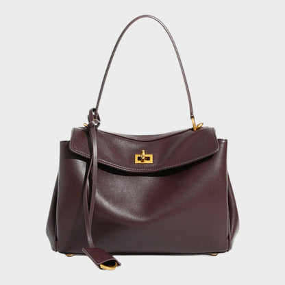 Cowhide leather shoulder bag featuring a magnetic flap closure, adjustable strap, and a lined interior for organized storage. 0