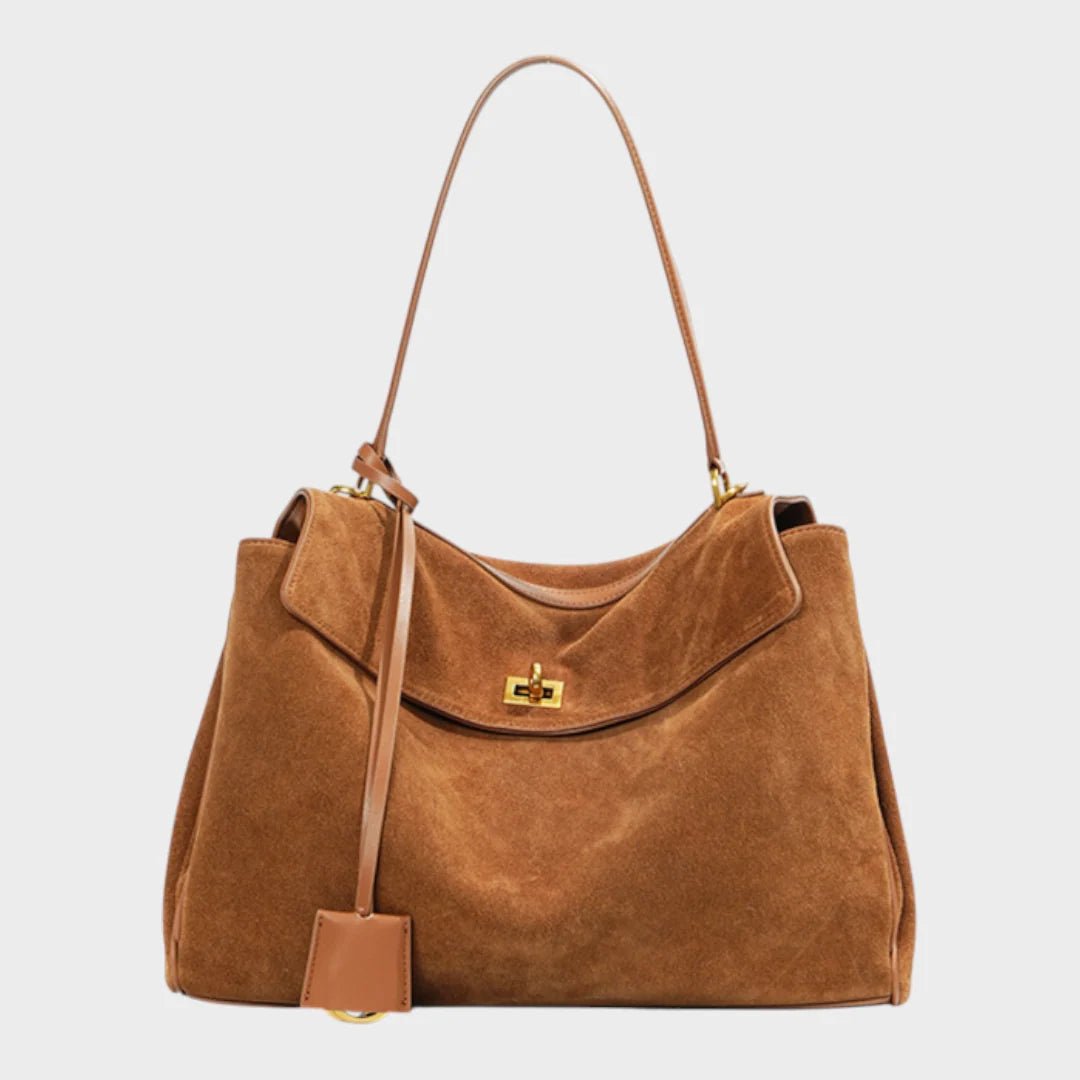 Cowhide leather shoulder bag featuring a magnetic flap closure, adjustable strap, and a lined interior for organized storage. 1