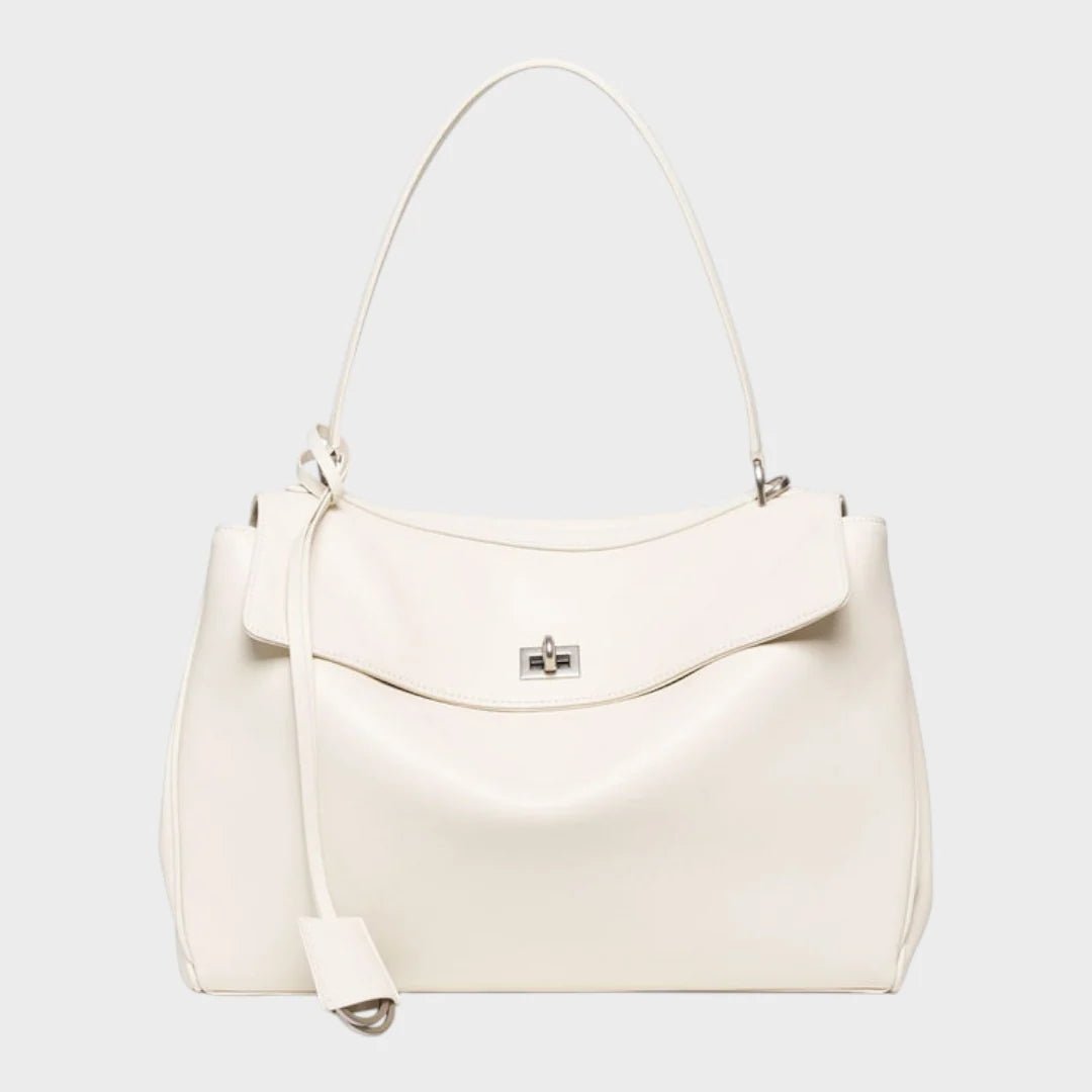 Cowhide leather shoulder bag featuring a magnetic flap closure, adjustable strap, and a lined interior for organized storage. 8