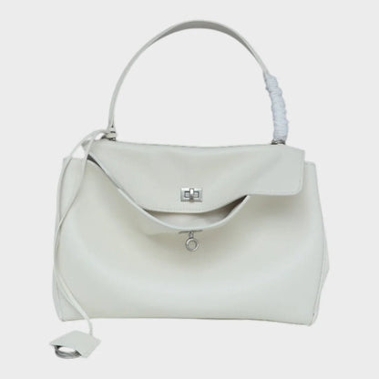 Cowhide leather shoulder bag featuring a magnetic flap closure, adjustable strap, and a lined interior for organized storage. 7