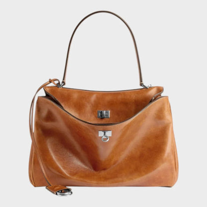 Cowhide leather shoulder bag featuring a magnetic flap closure, adjustable strap, and a lined interior for organized storage. 11