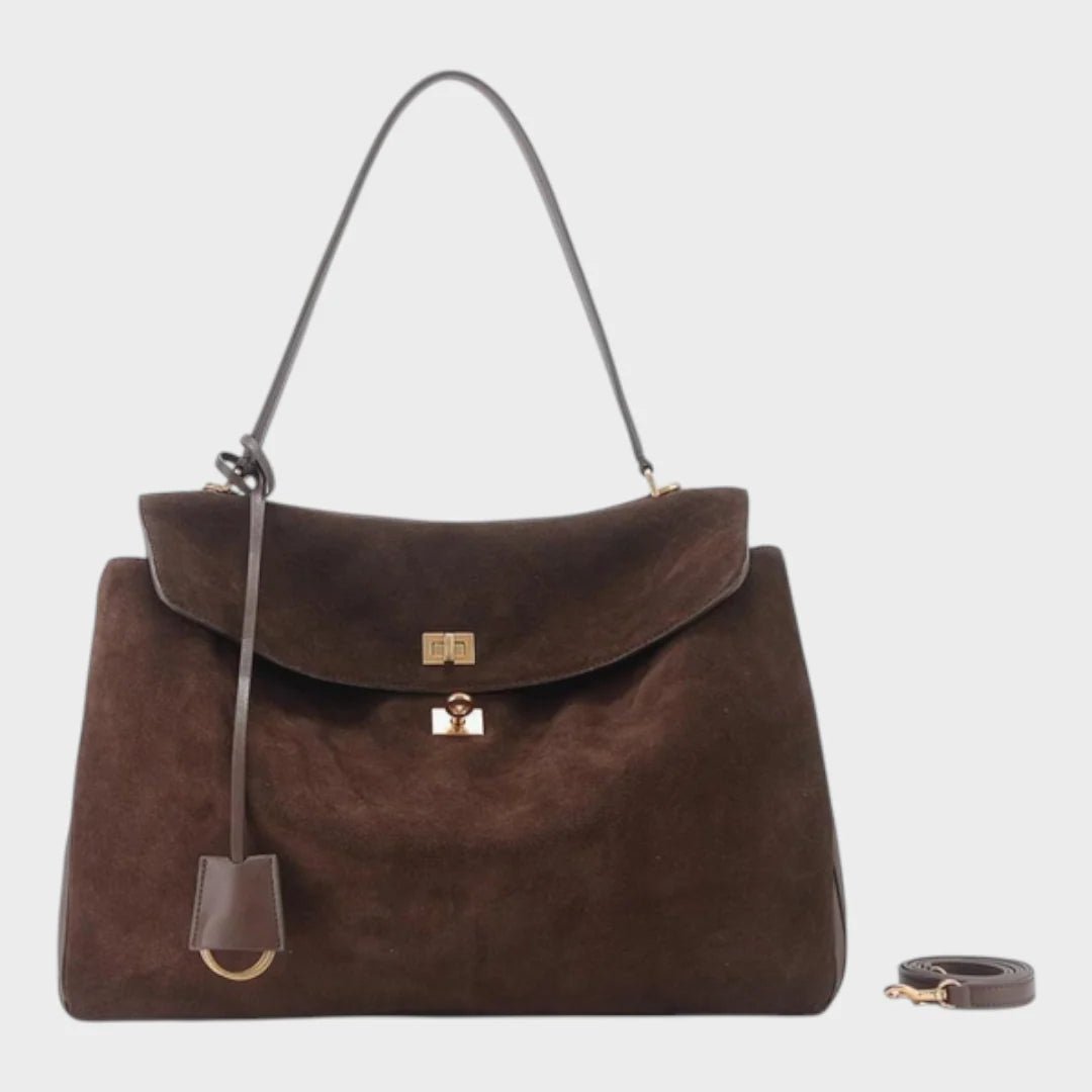 Cowhide leather shoulder bag featuring a magnetic flap closure, adjustable strap, and a lined interior for organized storage. 2