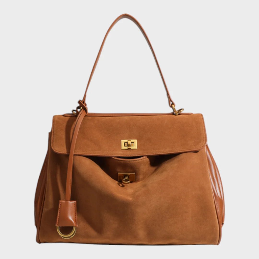 Cowhide leather shoulder bag featuring a magnetic flap closure, adjustable strap, and a lined interior for organized storage. 12