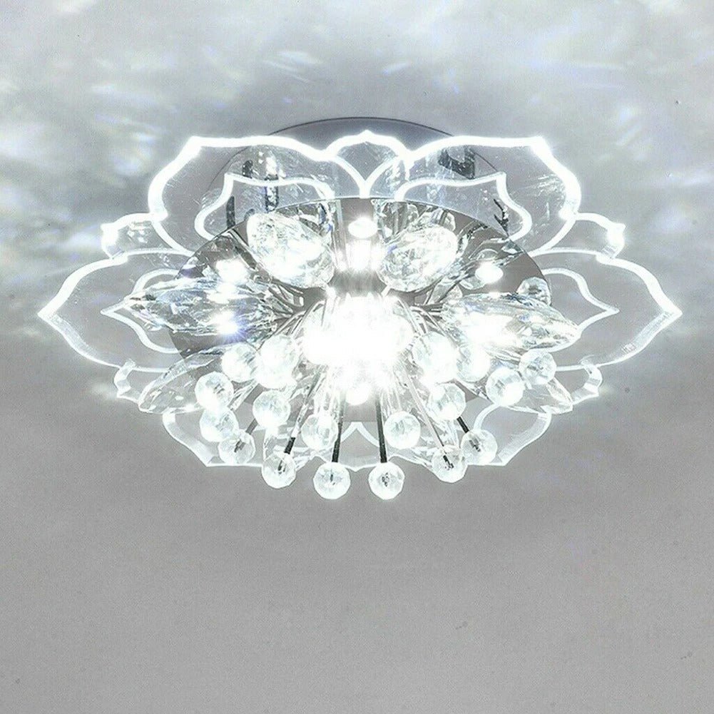 Elegant crystal chandelier featuring a modern flower design with gold accents and built-in LED lights, perfect for enhancing the ambiance of any room. 1
