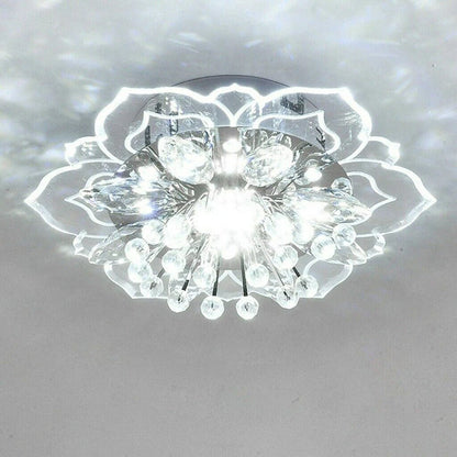 Elegant crystal chandelier featuring a modern flower design with gold accents and built-in LED lights, perfect for enhancing the ambiance of any room. 1