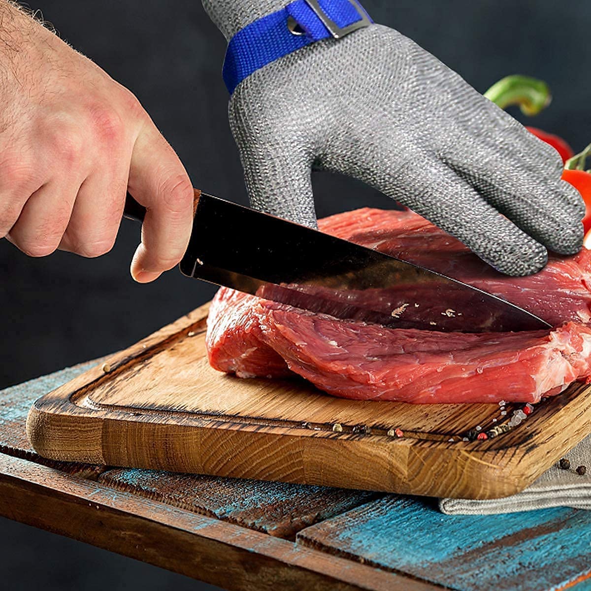 Cut resistant gloves featuring adjustable cuffs made of durable stainless steel mesh, designed for safe handling and protection in industrial and kitchen environments. 3