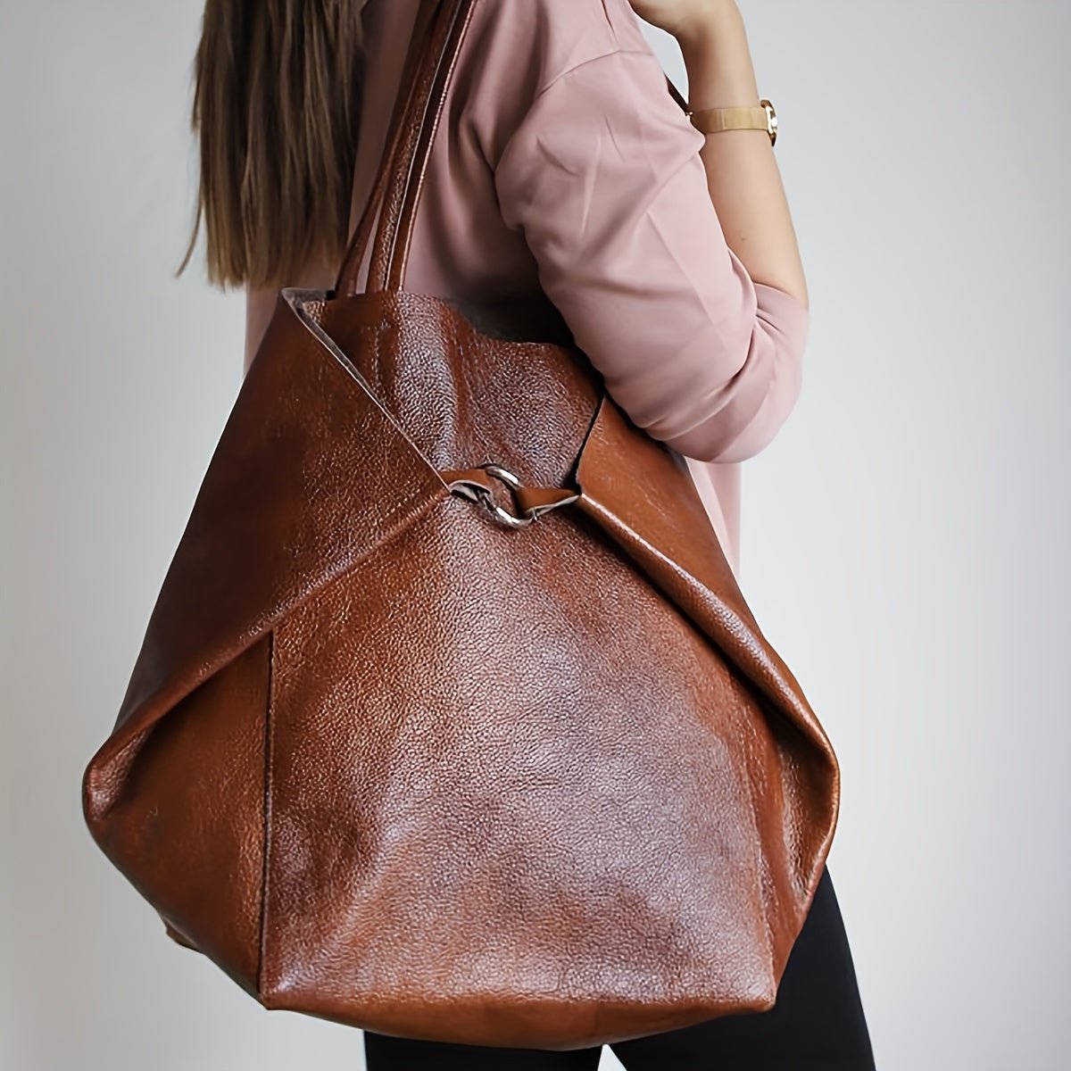 Dark brown leather tote bag featuring a secure buckle closure, perfect for versatile shoulder and sling use, ideal for everyday style and functionality. 5