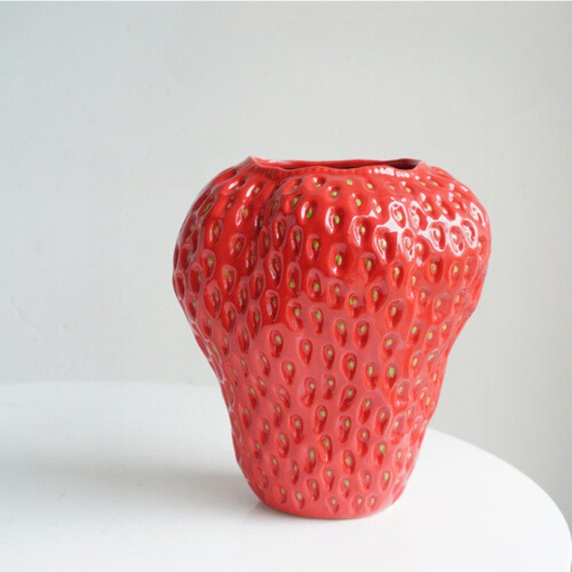 Decorative strawberry-shaped ceramic vase for flowers, featuring a unique and modern design, perfect for enhancing home decor. 11