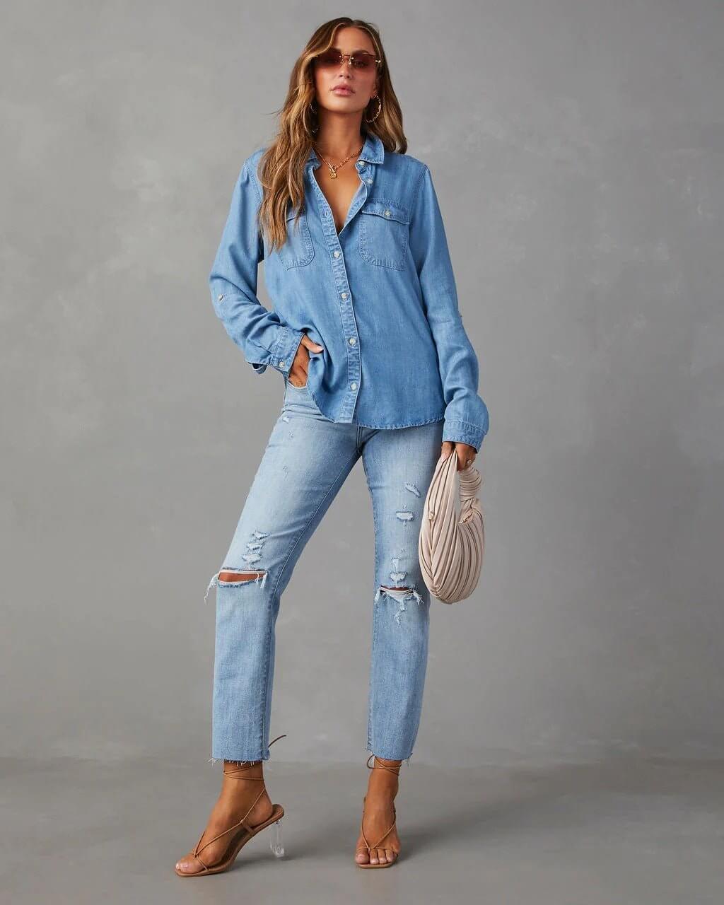 Denim shirt for women featuring a button front, long sleeves, classic collar, and curved hemline. 2