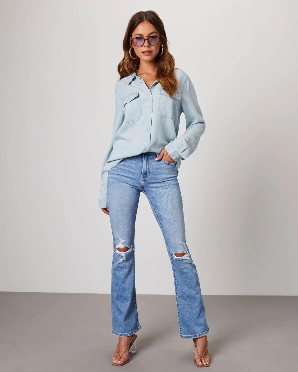 Denim shirt for women featuring a button front, long sleeves, classic collar, and curved hemline. 7