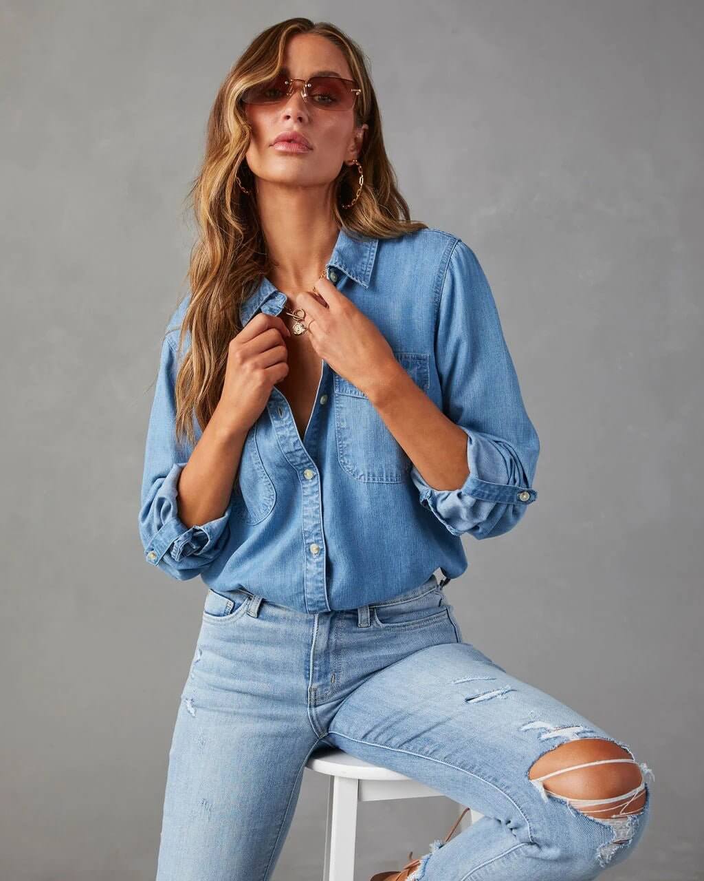 Denim shirt for women featuring a button front, long sleeves, classic collar, and curved hemline. 5