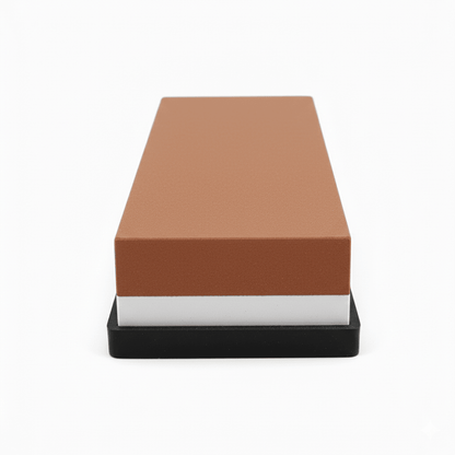 Double-sided sharpening stone with 2000/5000 grit for honing kitchen knives, featuring a non-slip base for stability during use. 1