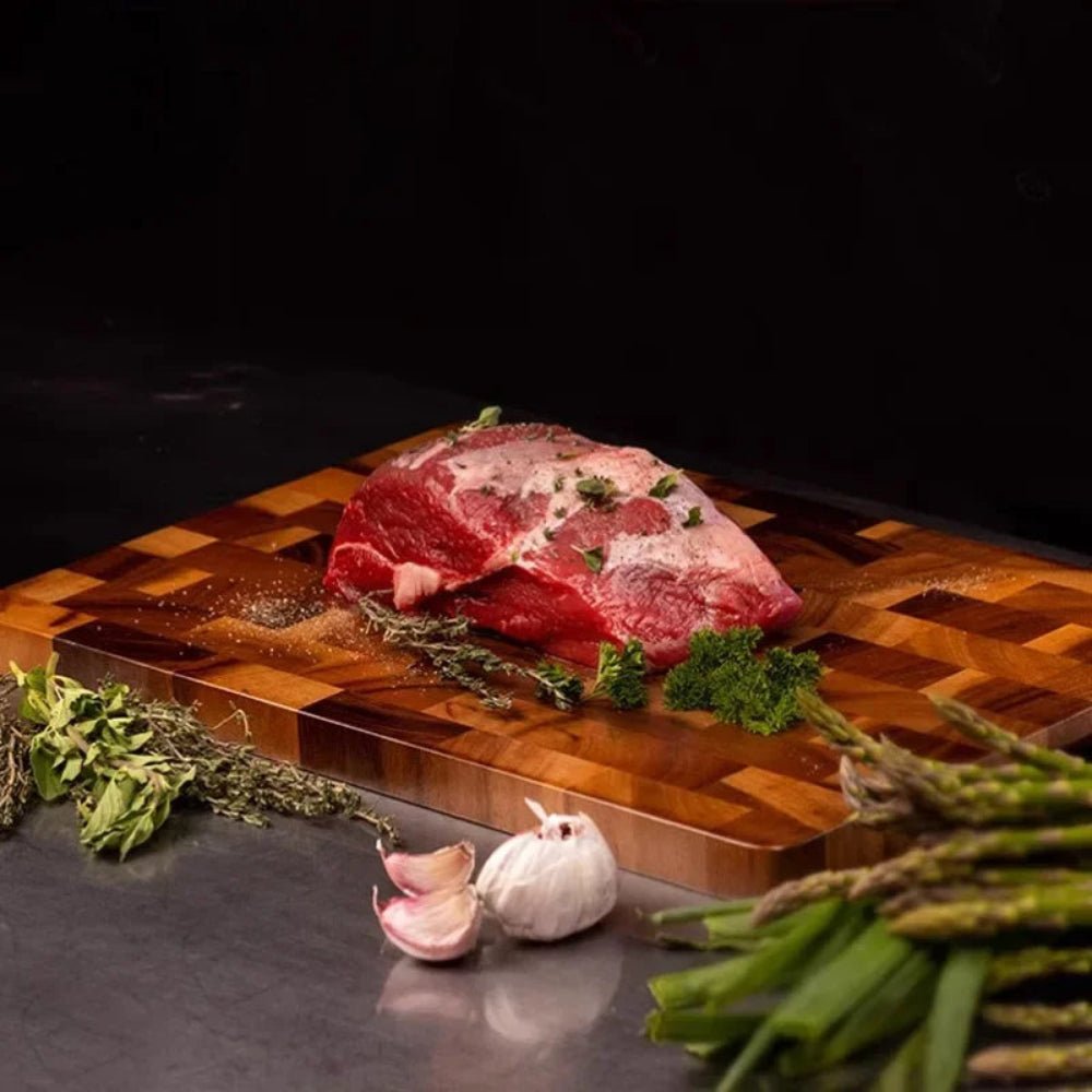 Double-sided wooden cutting board featuring drainage grooves, ideal for meal prep and versatile kitchen use. 1