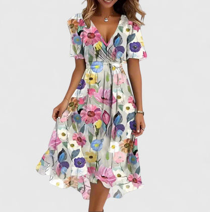 Elegant short dress featuring a vibrant floral design, delicate flutter sleeves, and a versatile high-low hemline perfect for any occasion. 5