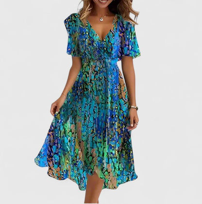 Elegant short dress featuring a vibrant floral design, delicate flutter sleeves, and a versatile high-low hemline perfect for any occasion. 1