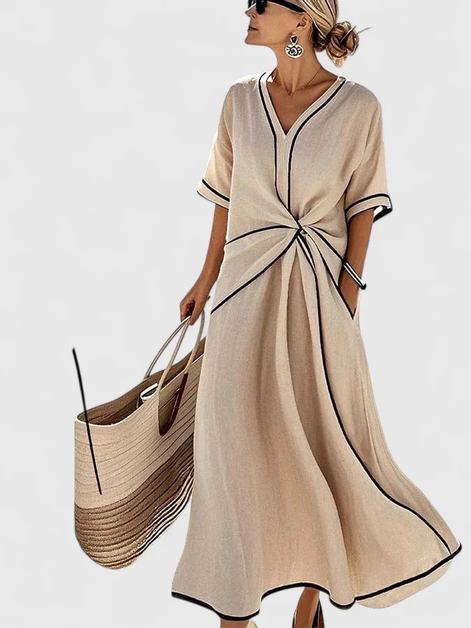 Elegant summer dress featuring vertical stripes, designed for a lightweight and breathable feel, perfect for warm weather occasions. 2