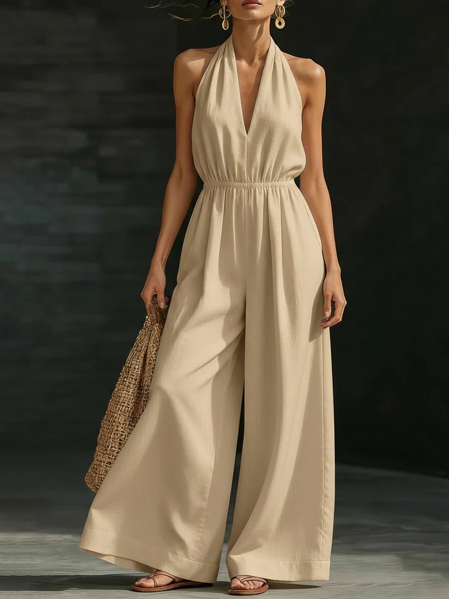 Elegant wide-leg jumpsuit featuring a lace overlay and adjustable halter tie, designed for women in soft, breathable fabric. 1
