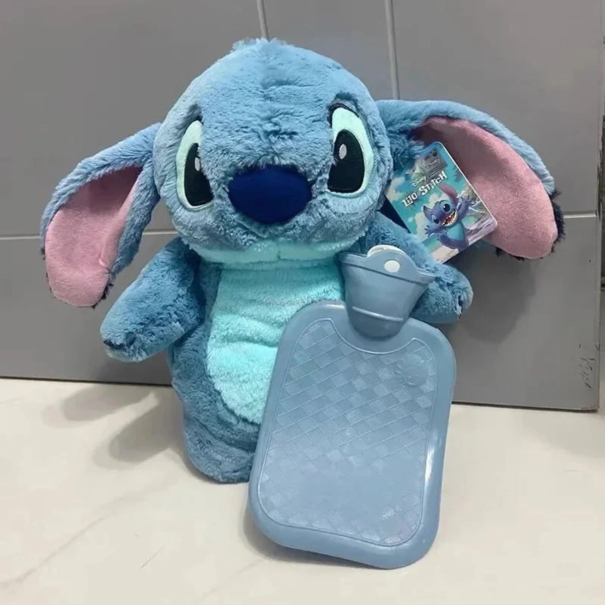Extra large plush hot water bottle featuring a soft Stitch cover, perfect for cozying up during winter as a hand warmer. 1
