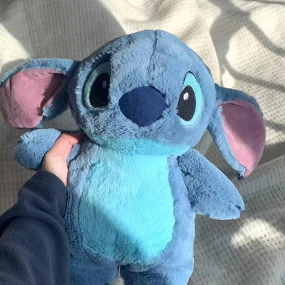 Extra large plush hot water bottle featuring a soft Stitch cover, perfect for cozying up during winter as a hand warmer. 2