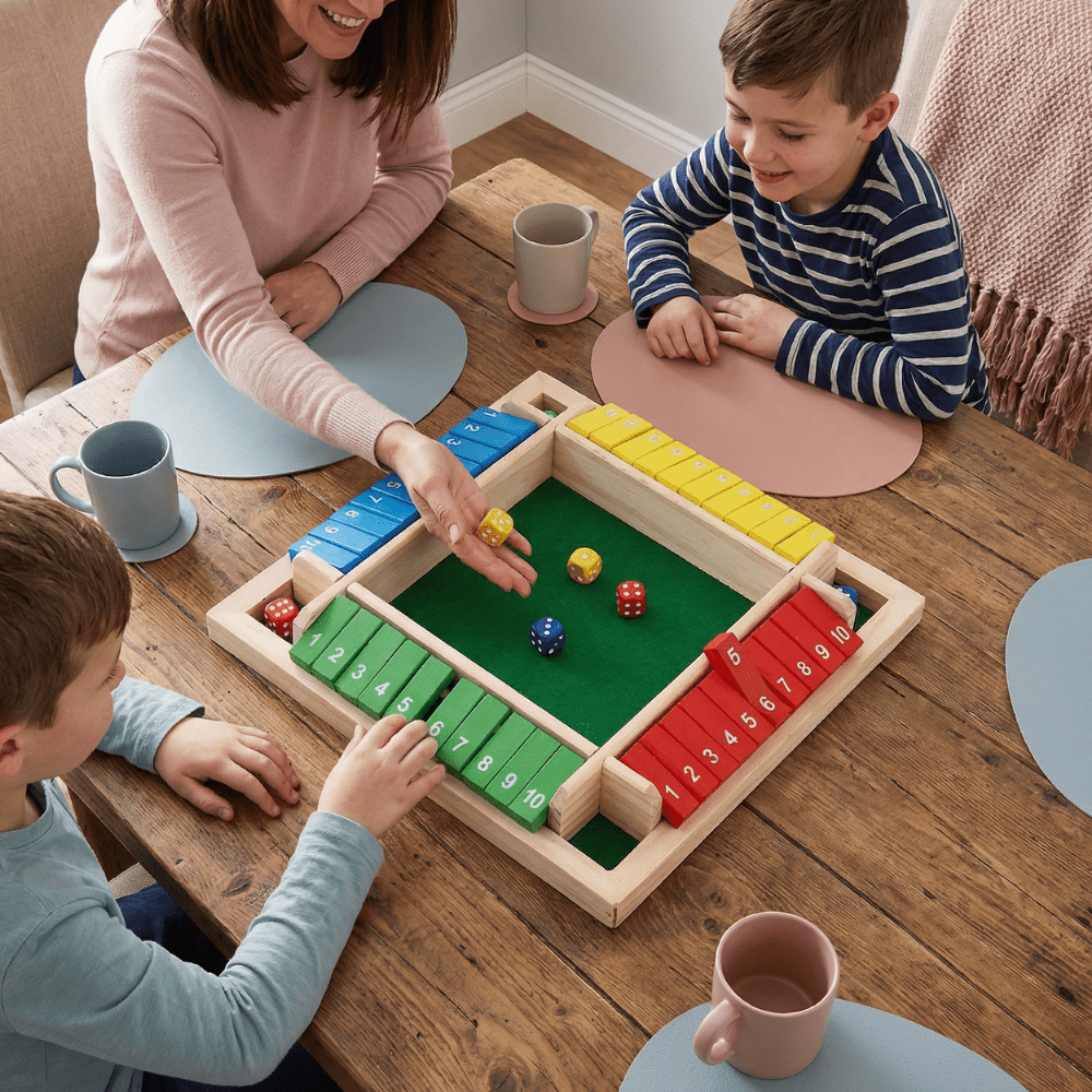 Family strategy board game featuring colorful wooden pieces and dice, designed for enjoyable tabletop play for all ages, promoting strategic thinking and family bonding. 1